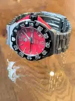 Tag Heuer Formula 1 WAC1113 men's watch with a red dial and stainless steel bracelet