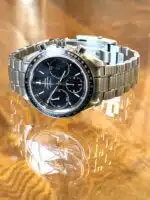 Omega Speedmaster Racing 326.30.40.50.01.001 mens watch with a black dial and stainless steel bracelet.
