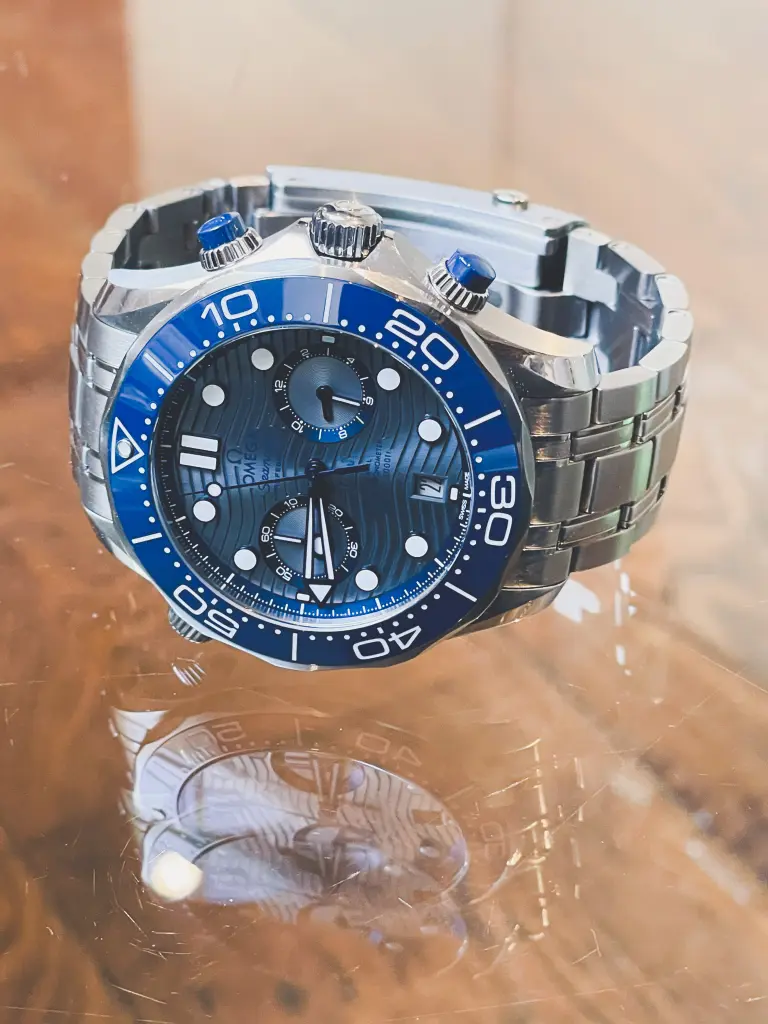 Omega Seamaster Diver 210.30.44.51.06.001 44mm men's watch with a grey dial and steel bracelet.