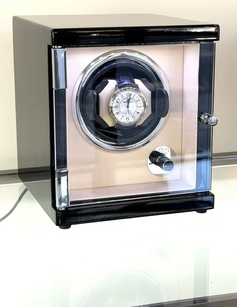 Watch winder, piano black case with redwood effect top, cream interior.