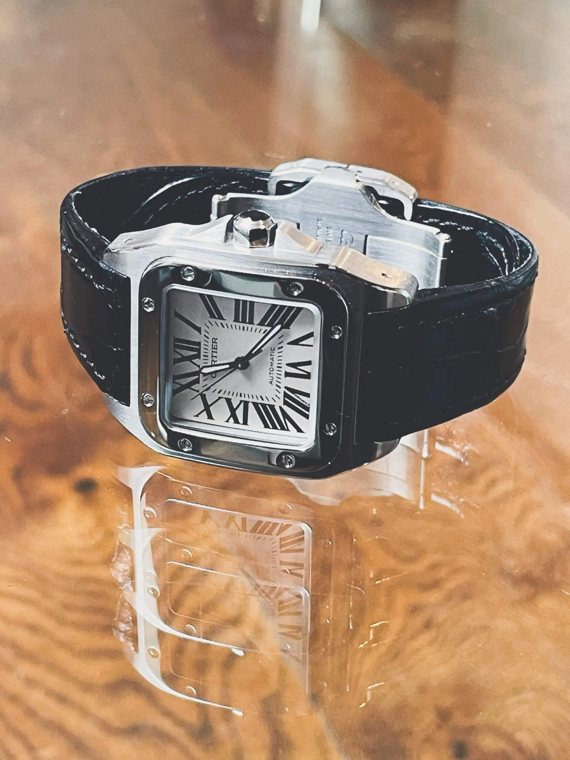 Cartier Santos 100 W20073XB 38mm Automatic 36mm Cartier Santos 100 W20073XB 38mm Automatic watch with a white dial and bLack leather strap.