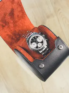 Genuine leather watch roll case in black and tan with suede lining.