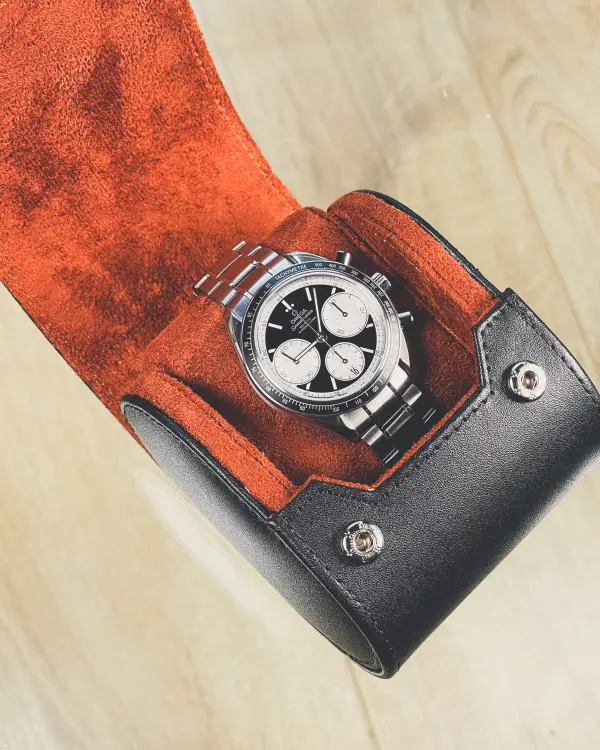 Genuine leather watch roll case in black and tan with suede lining.