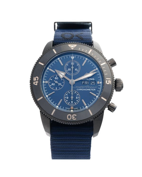 Breitling Superocean Heritage M13313 Outerknown men's watch with a blue dial, black dlc coated case and a blue nato strap.