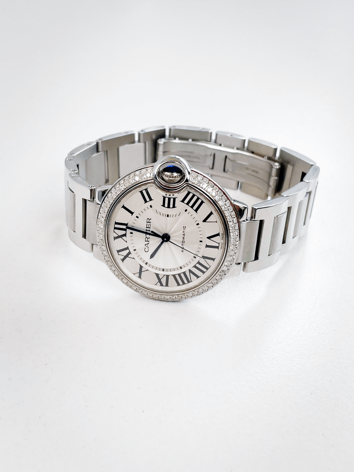 Cartier Ballon Bleu W6920046, silver dial, stainless watch with a diamond bezel.