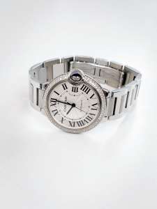 Cartier Ballon Bleu W6920046, silver dial, stainless watch with a diamond bezel.