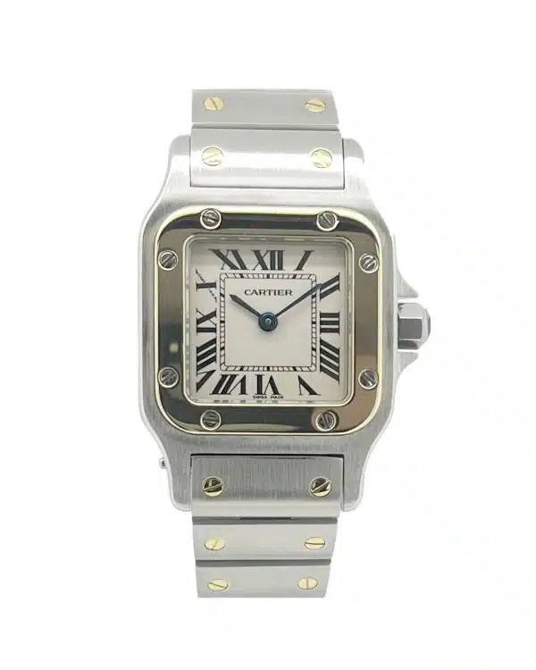 Cartier Santos Galbée Ref. 1567 two-tone wristwatch worn on a woman's wrist, featuring a stainless steel and yellow gold bracelet, silver dial with black Roman numerals, and blued steel hands. The watch is photographed on a marble café table beside a coffee cup and menu, with a softly blurred café background creating an elegant and sophisticated atmosphere.